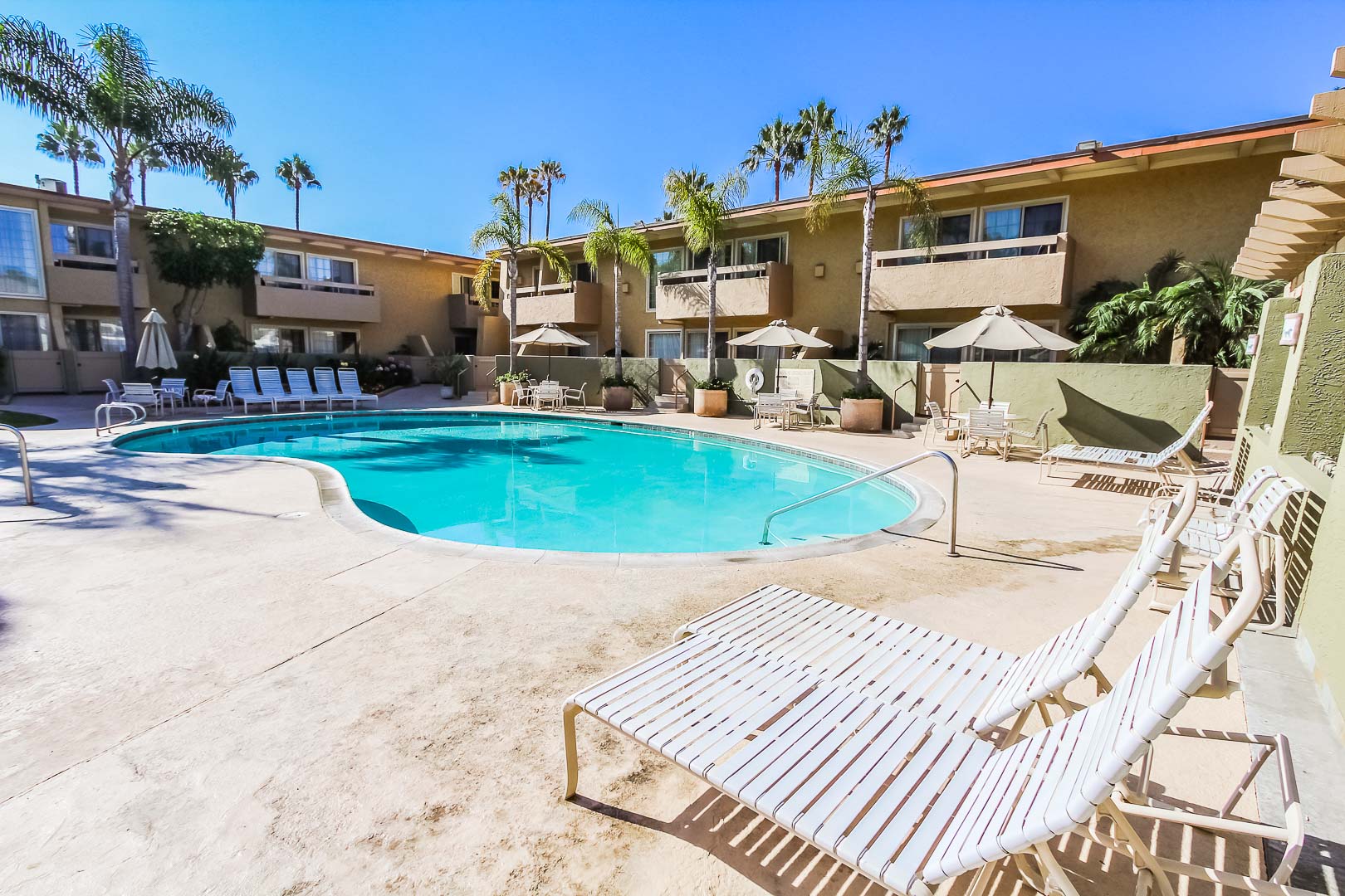 A spacious outdoor swimming pool at VRI's Winner Circle Resort in California.